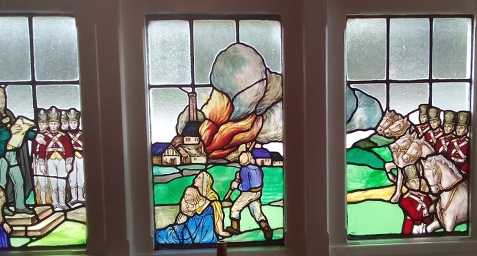 Stained glass window representing the burning of the Westhoughton Mill.
