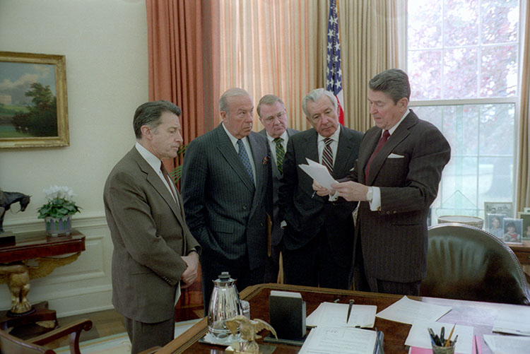 Caspar Weinberger, George Schultz, Edwin Meese, Don Regan, and President Ronald Reagan read notes before telecast.
