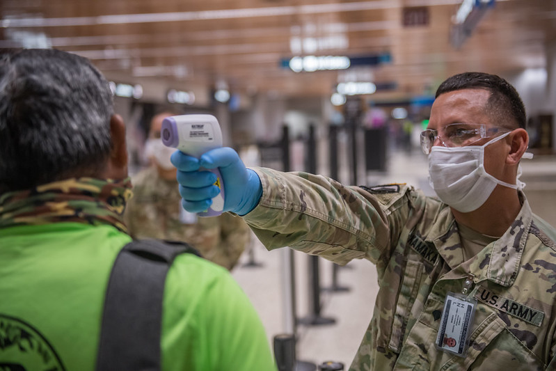 A Hawaii National Guardsman screens departing passengers at the Daniel K. Inouye International Airport.