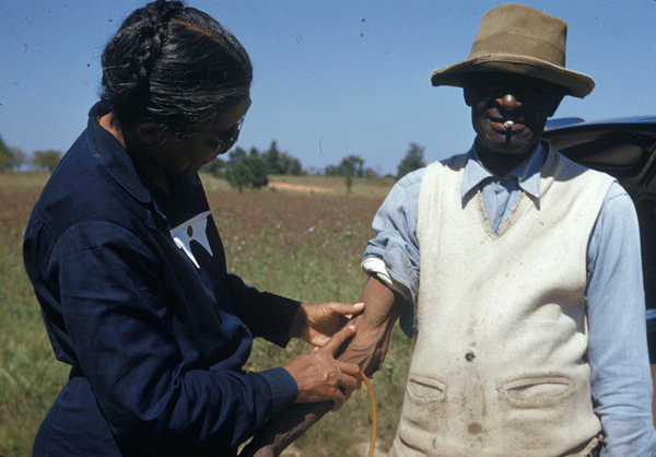 Eunice Rivers takes a blood sample from a test subject of the Tuskegee Syphilis Study.