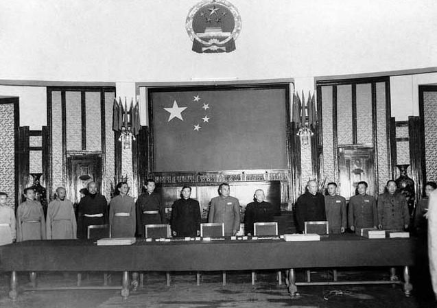 Delegates pose for a photo after signing the Seventeen Point Agreement in Beijing, 1951