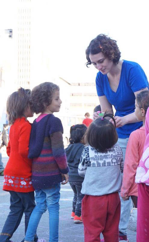 The author teaching a small Afghan girl to blow a bubble.