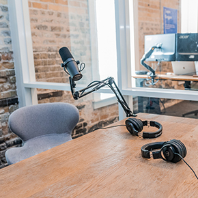 a recording studio with microphones and headphones on a desk