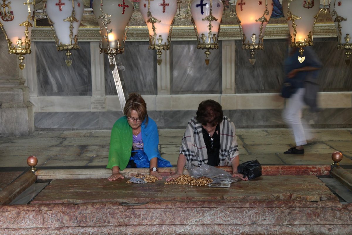 Christian pilgrims kneel to pray.
