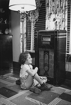 A child listens to the radio.