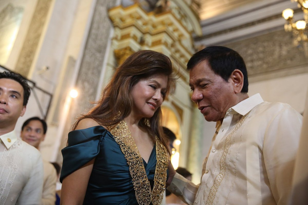President Rodrigo Duterte talks to Imee Marcos at a wedding ceremony in Manila, September, 2016