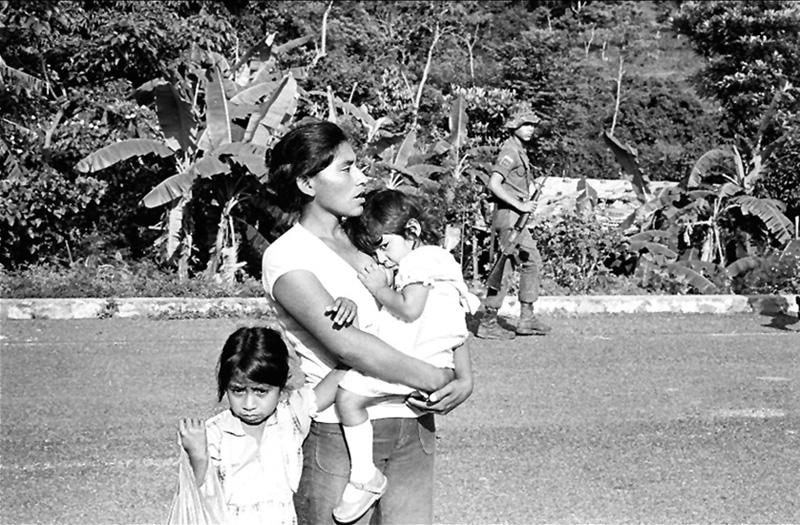 A woman and children at Guazapa Volcano on the road to Suchitoto during a battle to regain control of the town of Suchitoto from rebels in the summer of 1982.