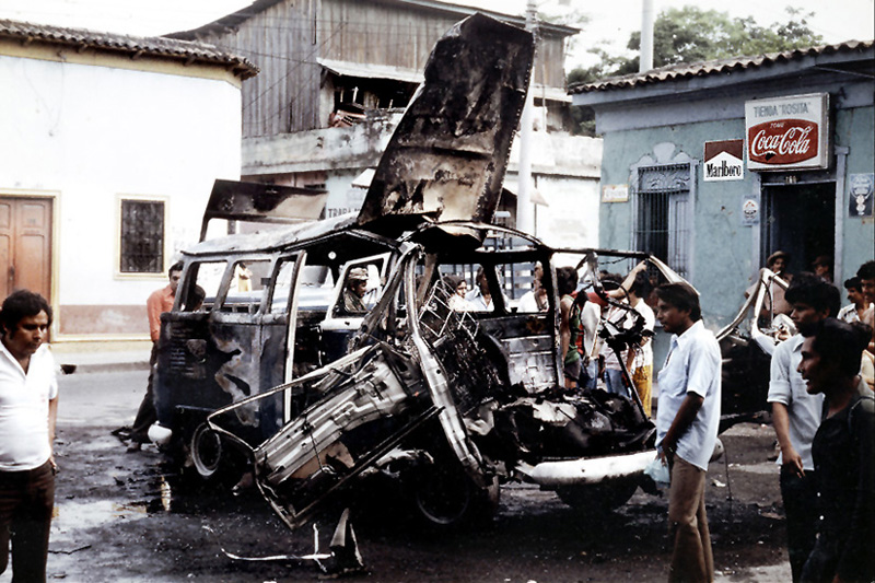 The bombing of buildings and vehicles on the outskirts of San Salvador was a regular occurrence by the rebels, such as this incident from 1982.
