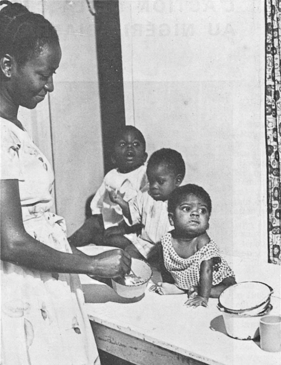 A French Red Cross-sponsored aid worker feeds Biafran children, 1968.