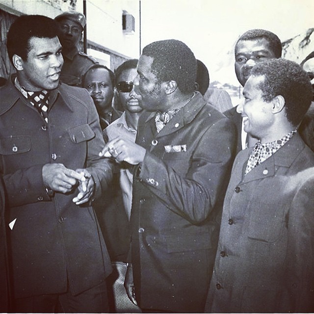 Ali, left, walking through the streets of Kinshasa in 1974.