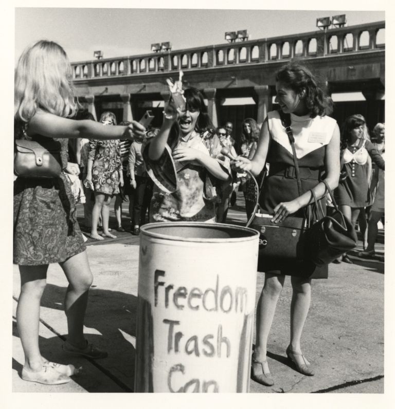 Throwing items into the Miss America Freedom Trashcan.