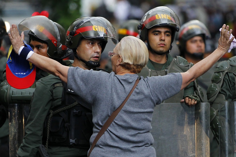 A protestor attempting to block the police during 'the mother of all marches' in April 2017.