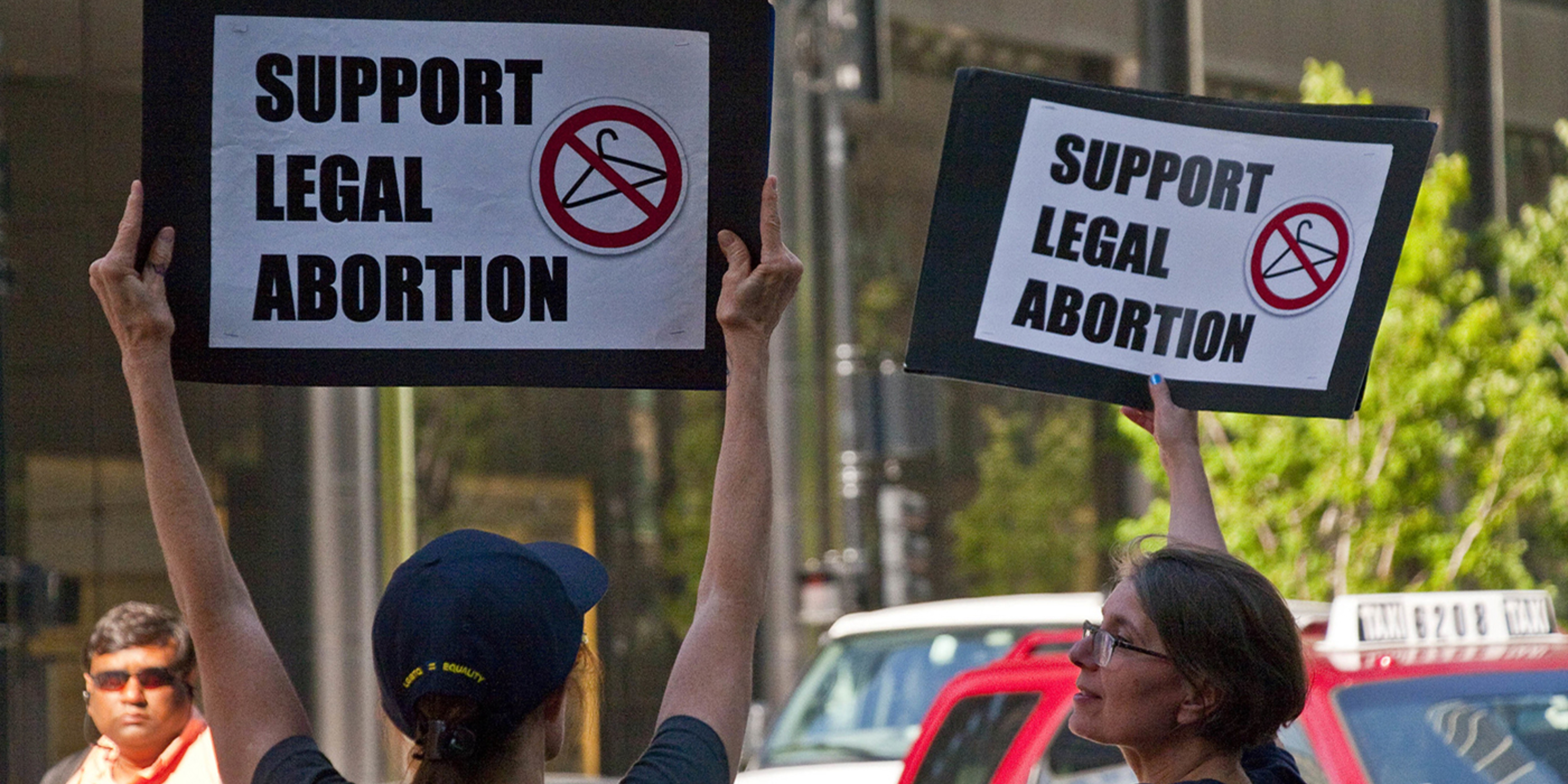 Pro-Choice demonstrators holding signs saying "Support Legal Abortion"