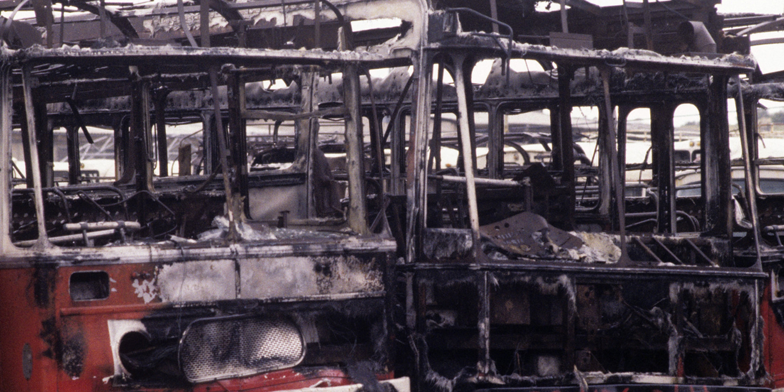Shells of burnt-out busses after a suicide bombing