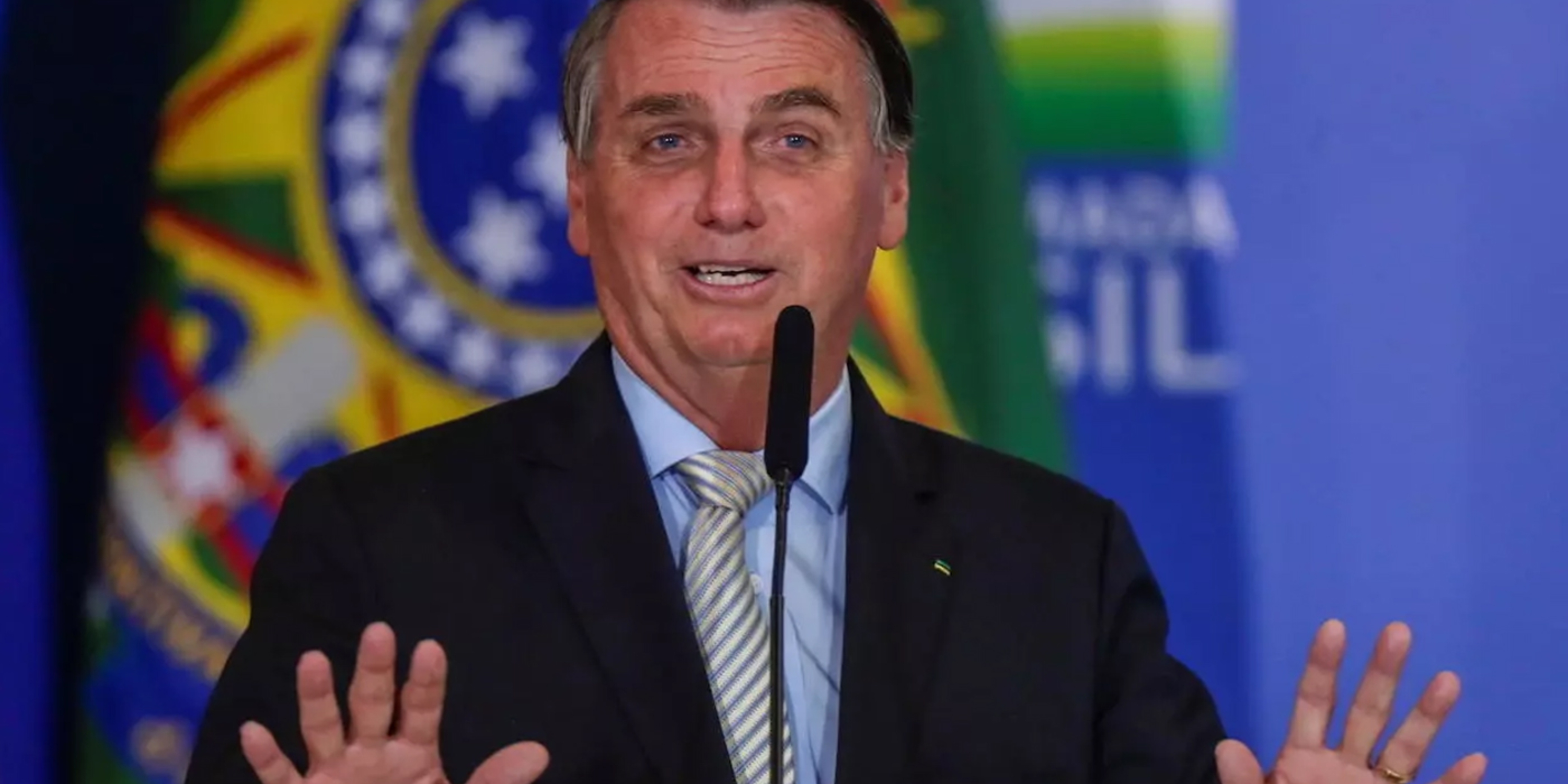 Jair Bolsonaro speaking at microphone