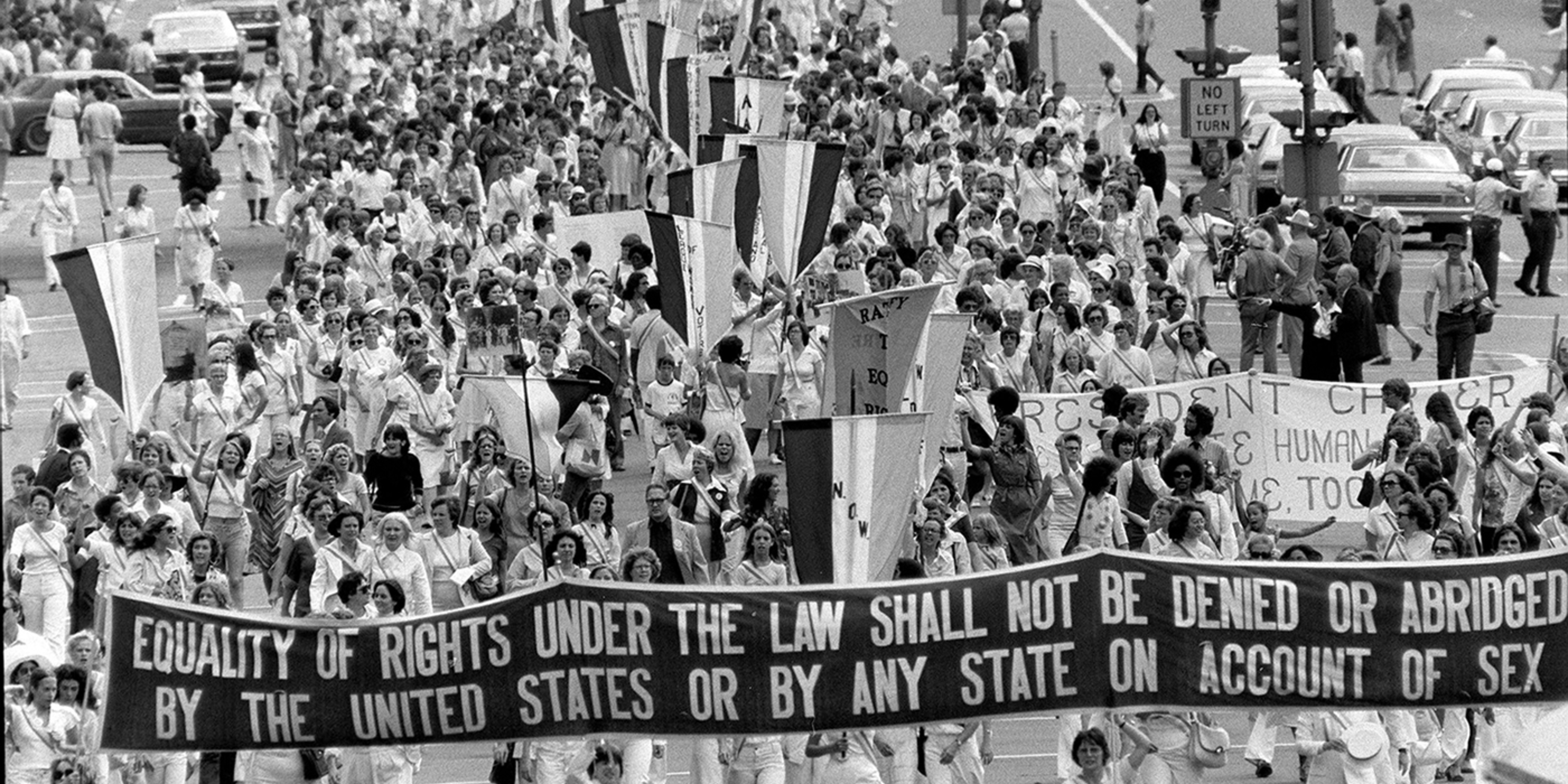 Marchers for the Equal Rights Amount, holding banner that reads "Equality of rights under the law shall not be denied or abridged by the United States or by any state on account of sex"