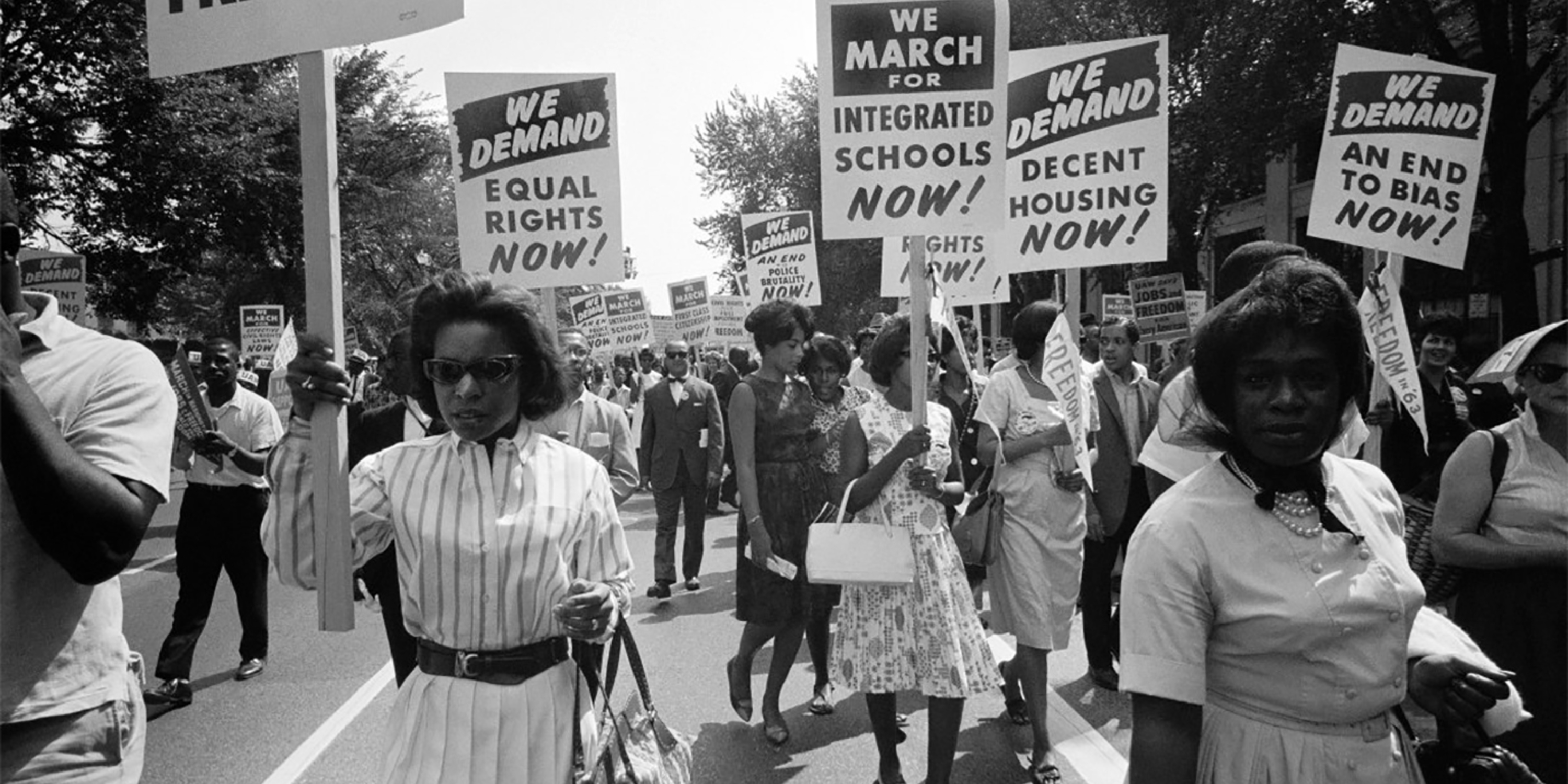 Black women marching with signs supporting integration