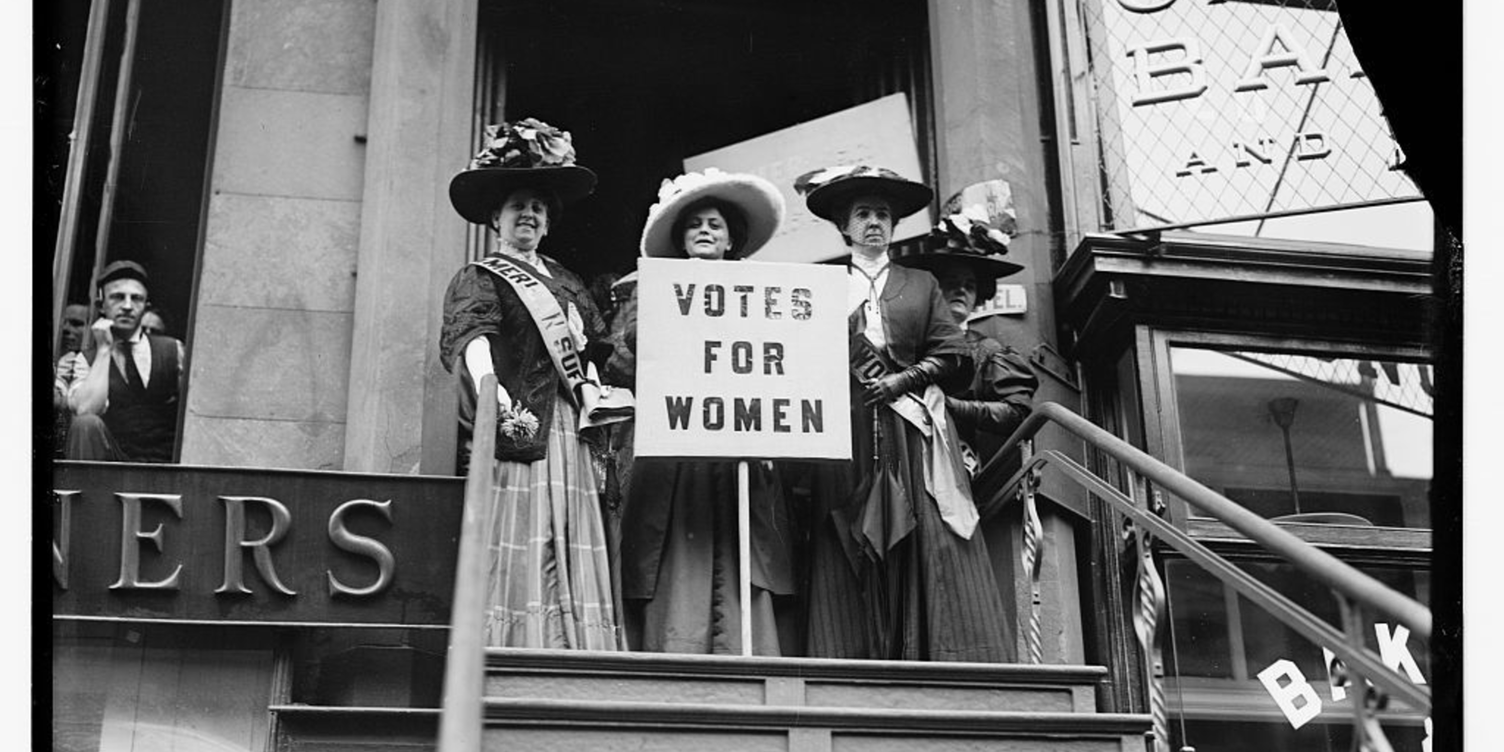 Suffragists with signs: "Votes for Women"