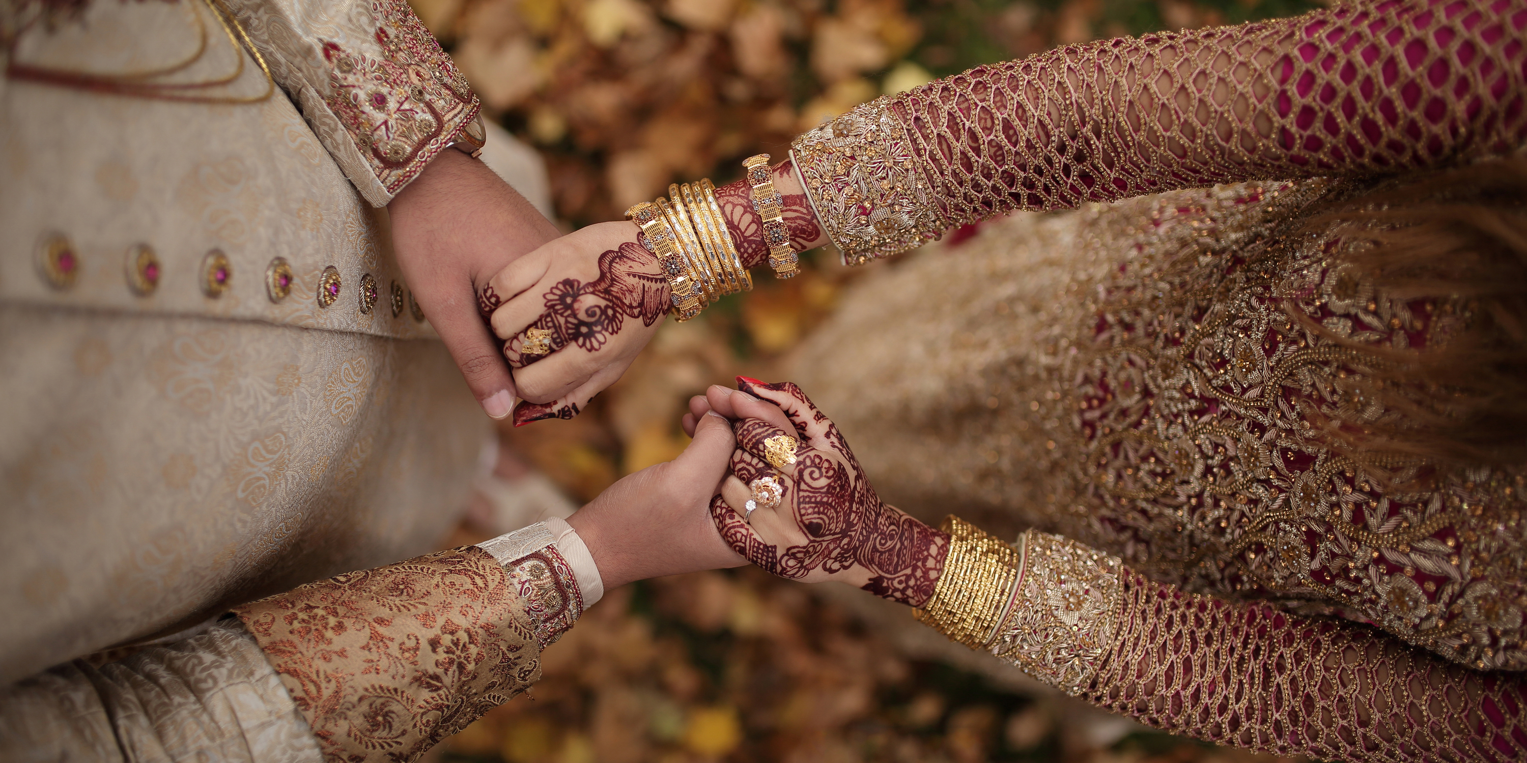 Close-up of Indian couple's hands during wedding ceremony