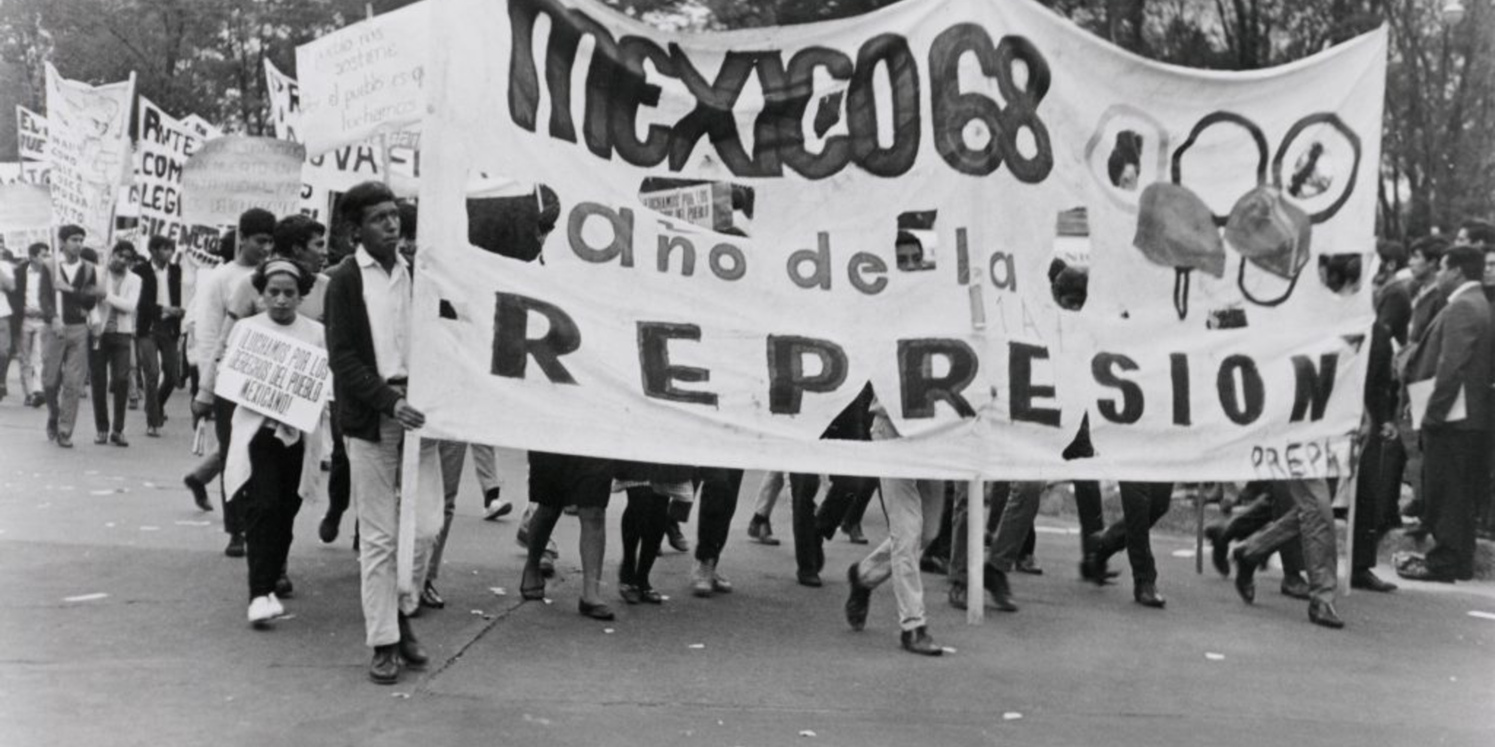 Students in Mexico protest the PRI in 1968 with a sign that reads "Mexico '68: The Year of Repression."