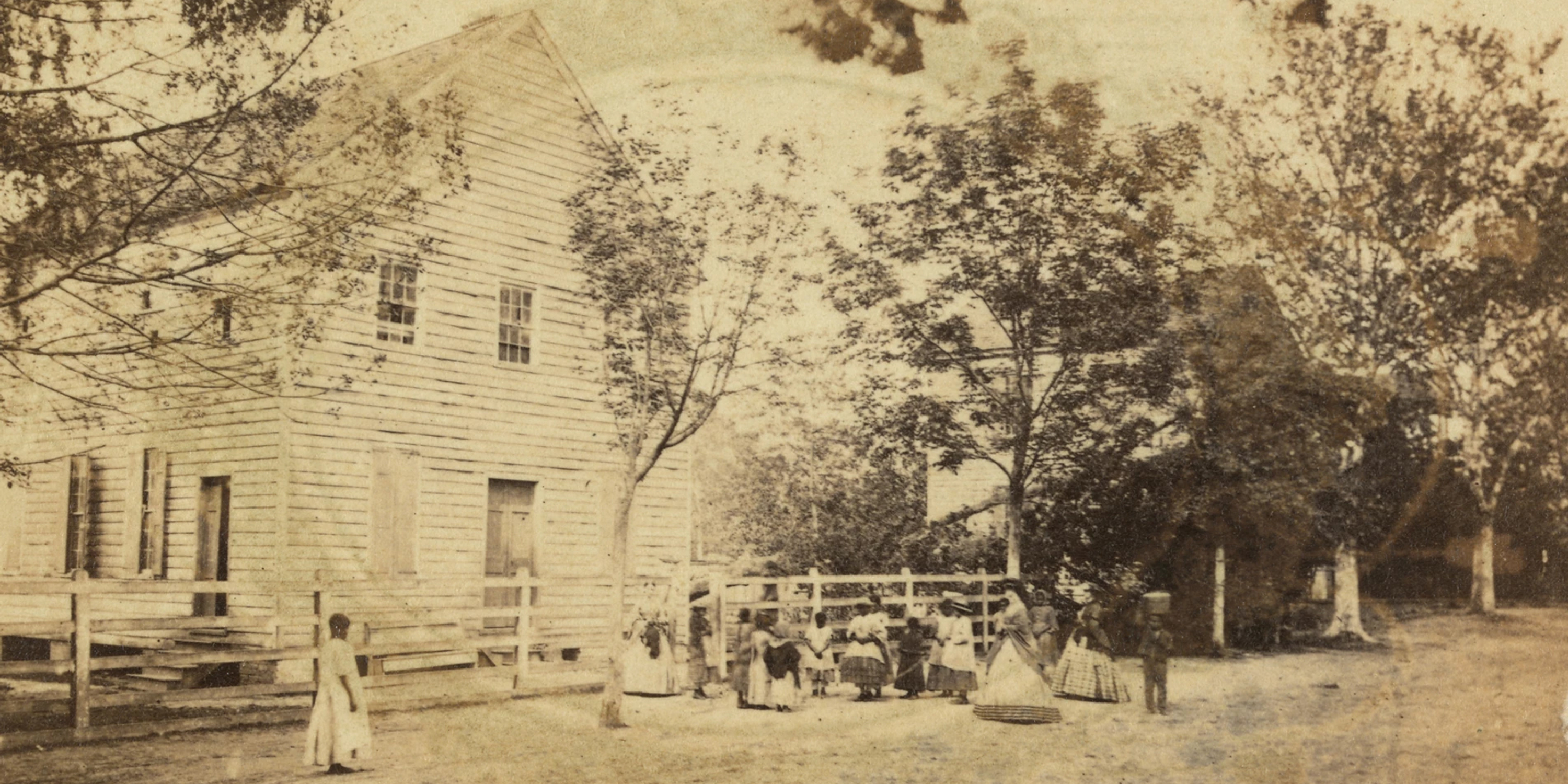 Black men and women in yard outside building - Photo by Archive Photos/Stringer/Getty Images