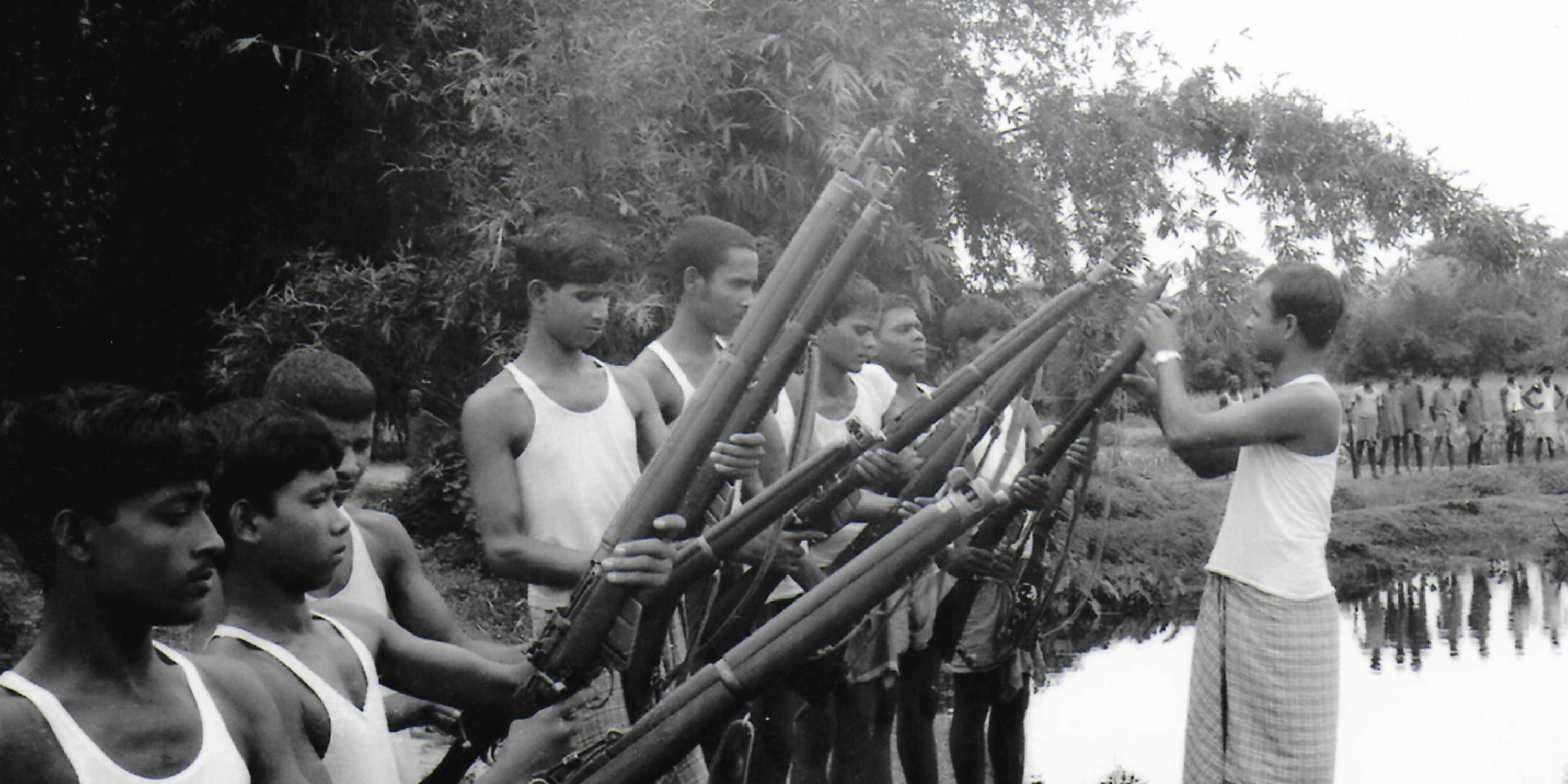 soldiers holding guns near a body of water