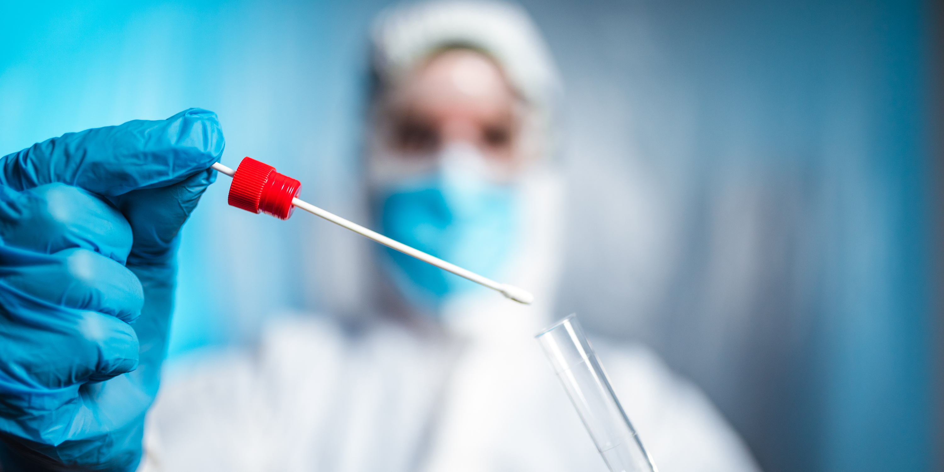 doctor holding a COVID swab