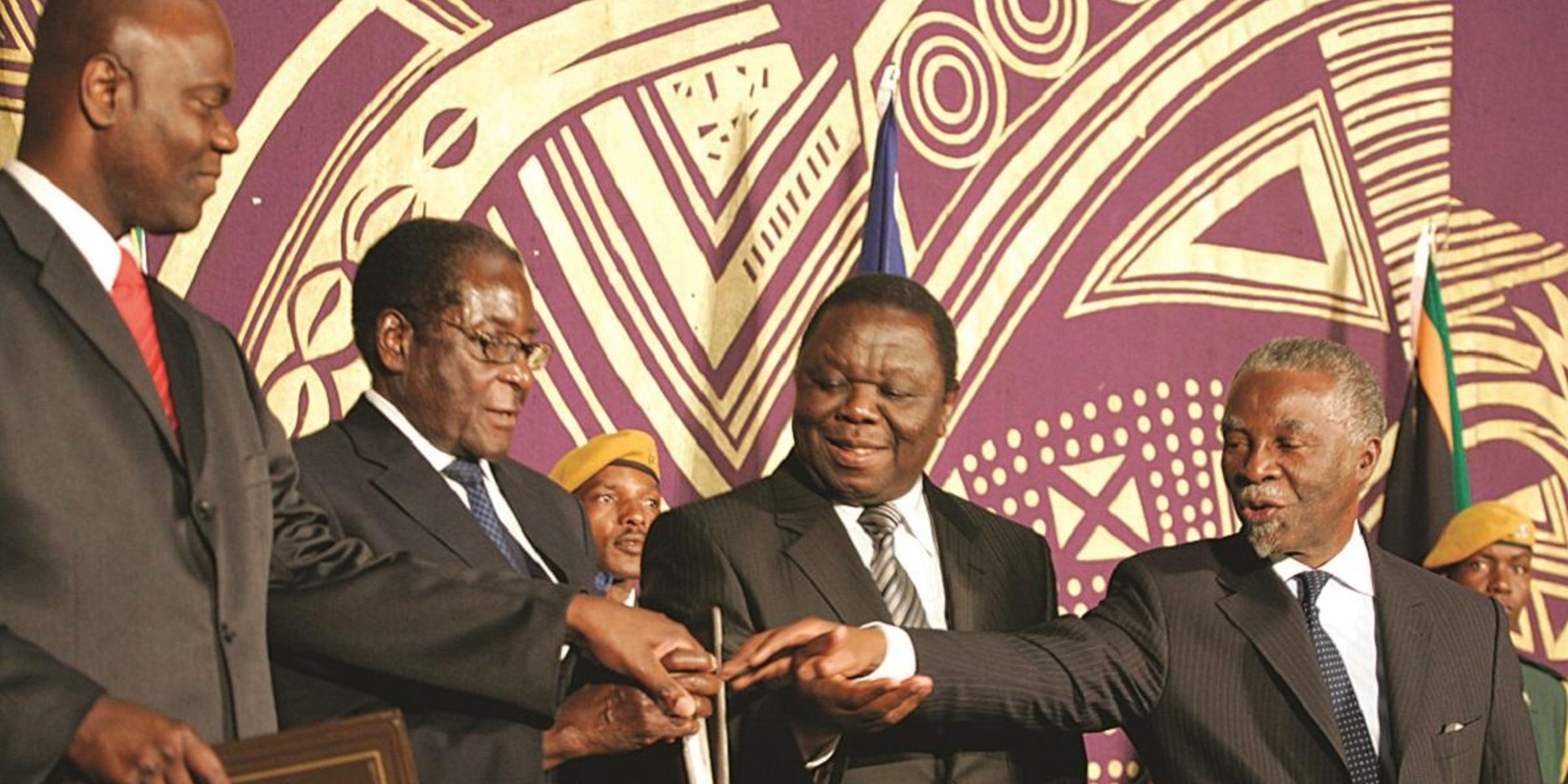 Government of National Unity in 2009. Left to right: Arthur Mutambara, Robert Mugabe, Morgan Tsvangirai, and Thabo Mbeki.