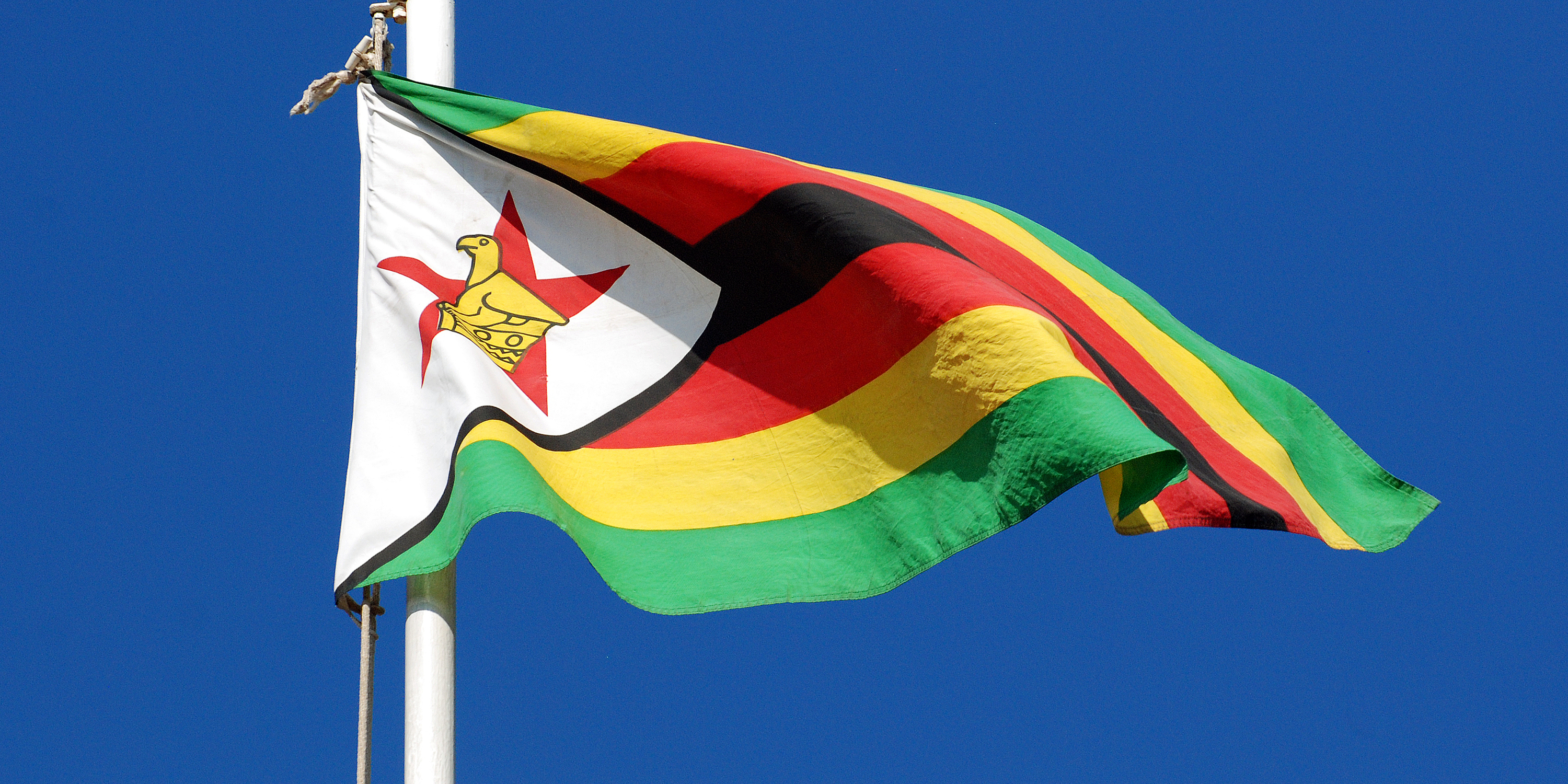Zimbabwe Flag against a blue sky