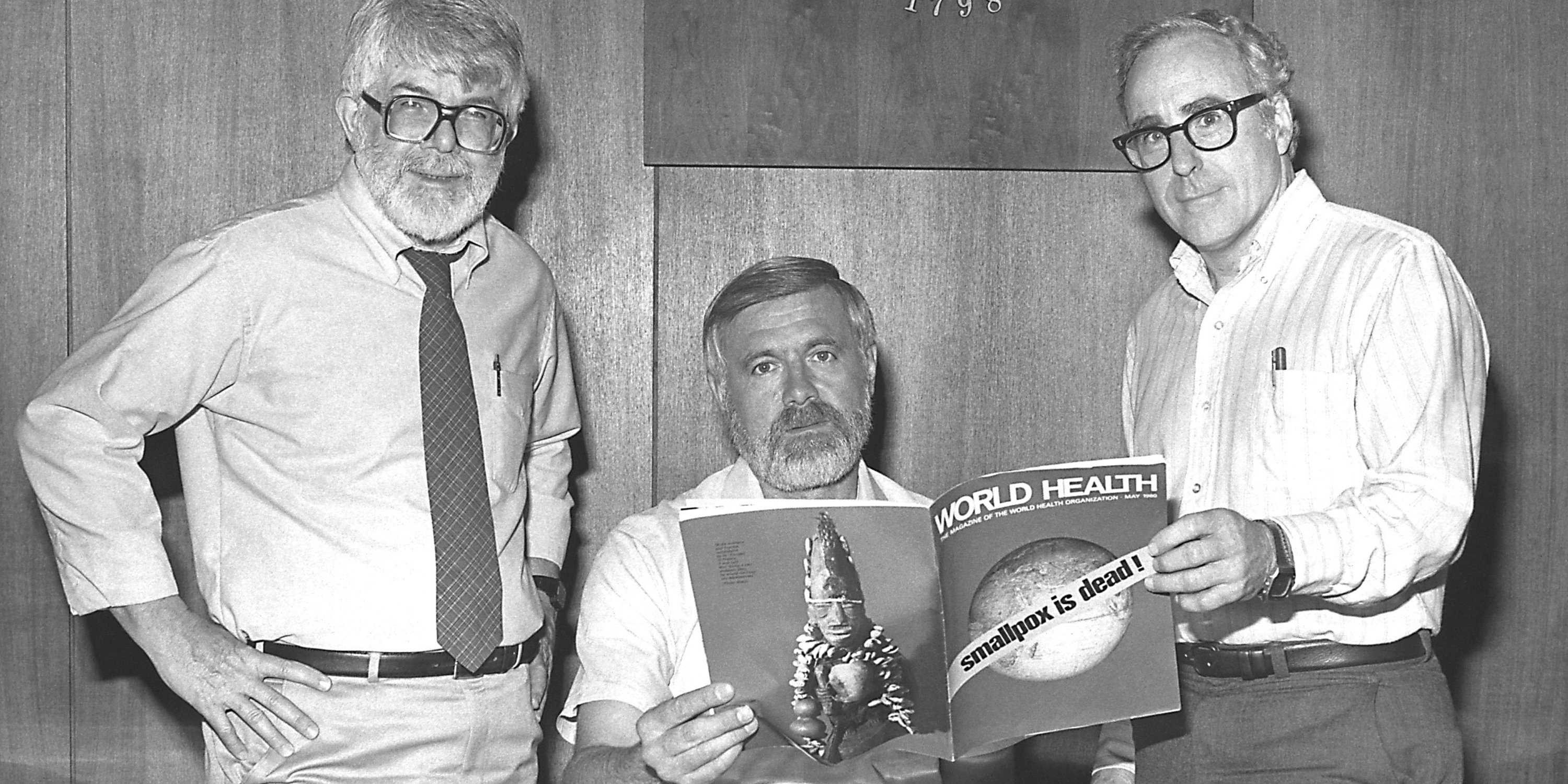 Three former directors of the Global Smallpox Eradication Programme read the news that smallpox had been globally eradicated, 1980.