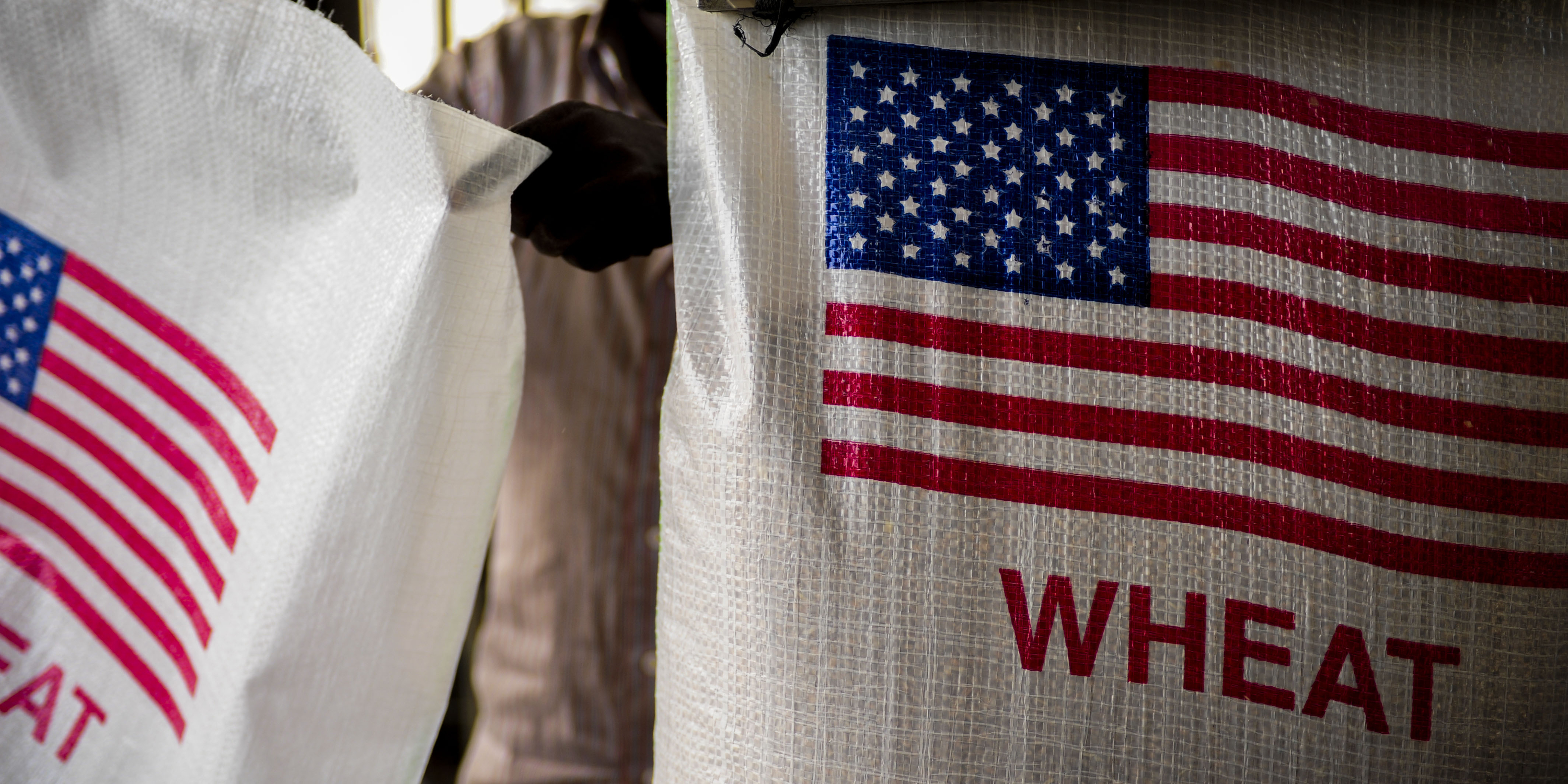 Djiboutian workers fill bags with wheat destined for Ethiopia, provided by the United States Agency for International Development (USAID), at the Port of Djibouti, Africa, Jan. 7, 2013. 