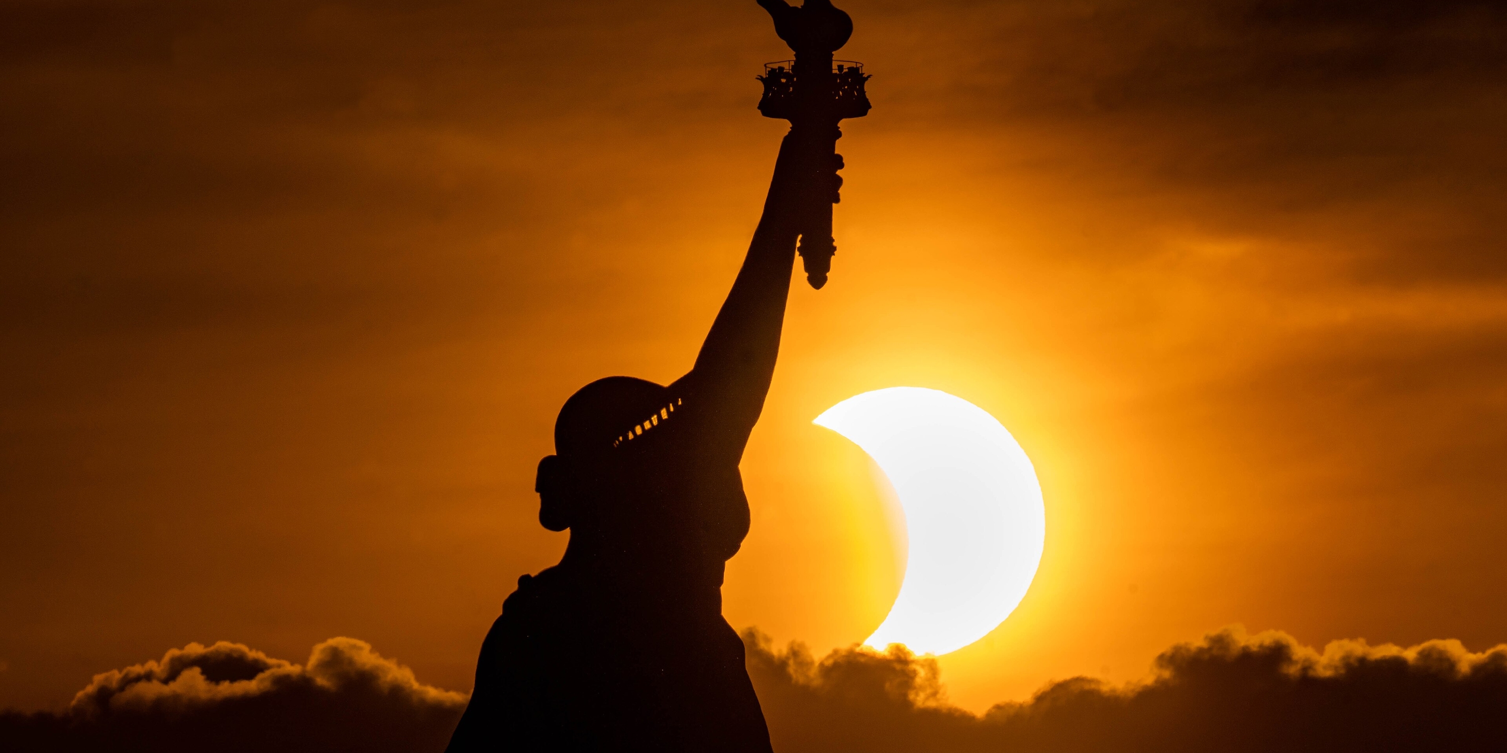 The statue of liberty during the sunset