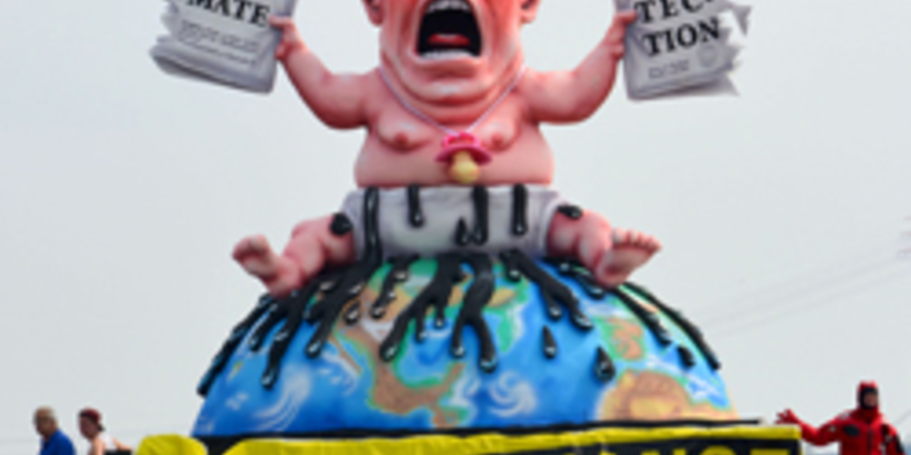 Trump Baby Sculpture with sign that reads time for a change