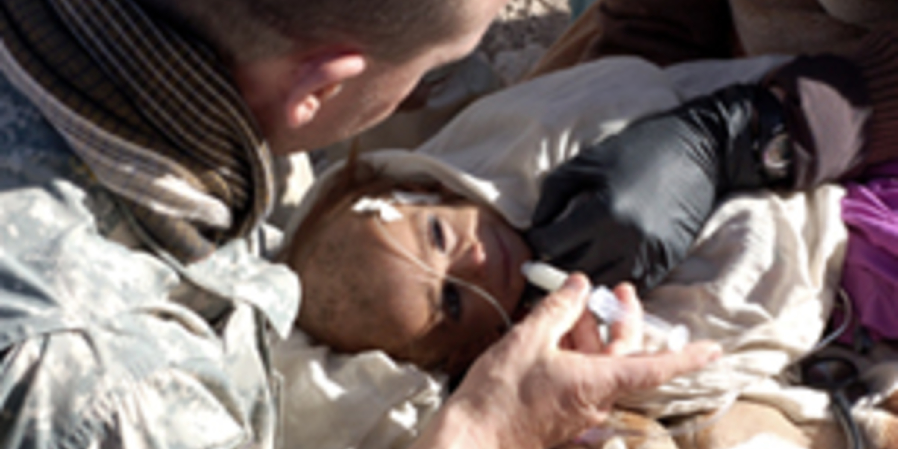 male nurse holding syringe over small baby