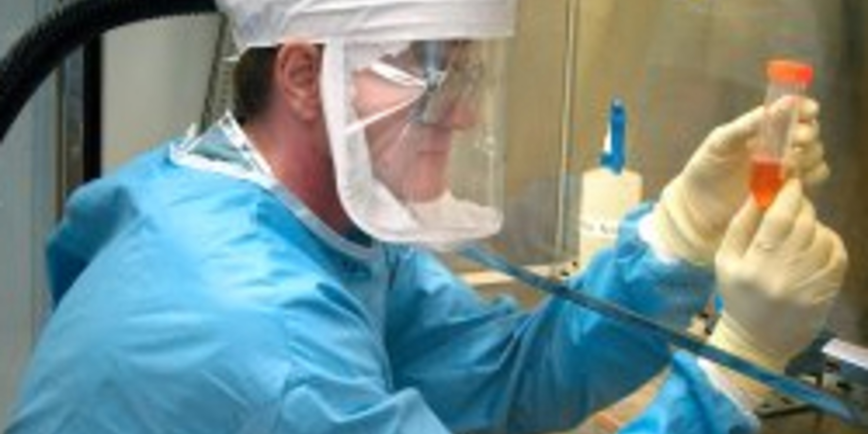 a researcher looking at a test tube of liquid