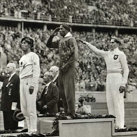 Naoto Tajima, Jesse Owens, and Luz Long at the medal ceremony for the long jump in 1936