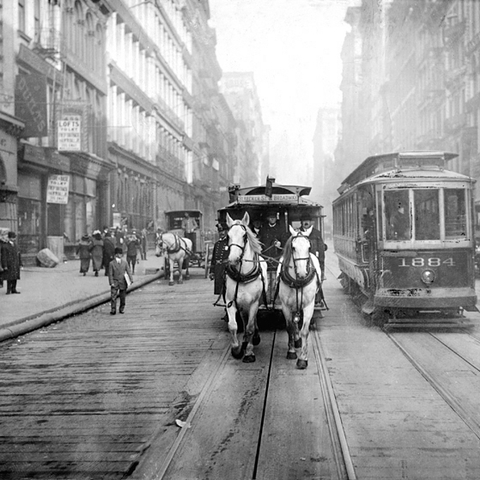 This 1917 photograph shows one of the last horse drawn carriages in New York as it moves alongside a 'Modern Electric Car.'