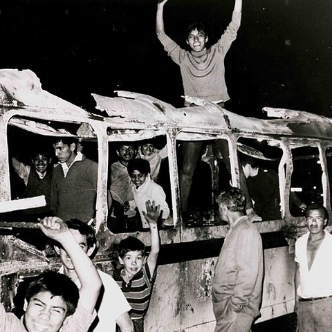 Student protesters on a burned-out bus in July 1968.