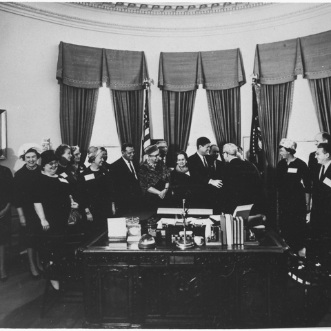 President John F. Kennedy meeting with Eleanor Roosevelt and other prominent women.
