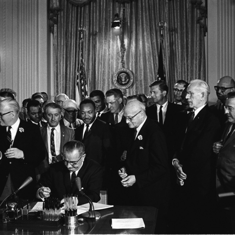 President Lyndon Johnson signing the Civil Rights Act of 1964.