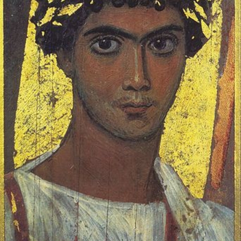 A mummy portrait of a young man in a gold wreath.