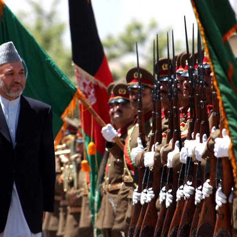 Hamid Karzai reviews troops of the first graduating class, for the 1st Battalion, Afghan National Army (ANA), during a ceremony held at the Kabul Military Training Center in Kabul, Afghanistan, 2002  