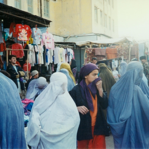 A clothing bazaar with female shoppers in Mazar-i Sharif, 1996  