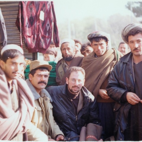The author (crouching, middle) with a military commandant (crouching to his right, mustache and billed hat) in Mazar-i Sharif, 1996  