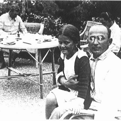 Laverenti Beria, early Georgian politician, holding Stalin's daughter with Stalin in the background