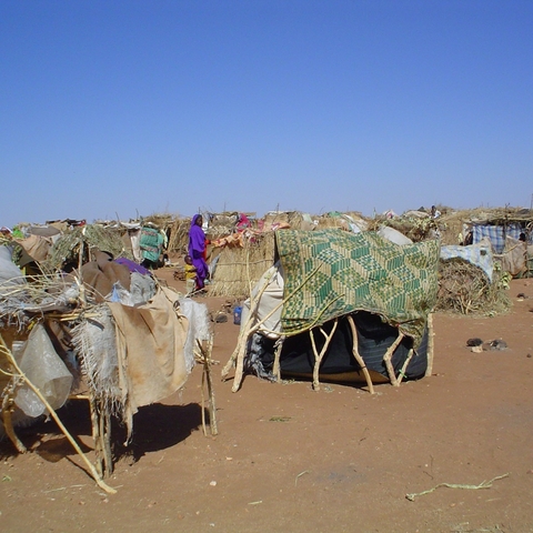 Internally Displaced Persons (IDPs) use sticks and scraps of plastic to construct makeshift shelters at Intifada transit camp near Nyala in South Darfur.