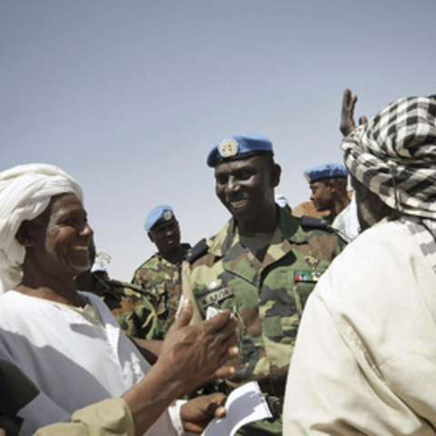 Brigadier General Bala Keita (fifth from left), military commander of the United Nations-African Union Hybrid Mission in Darfur (UNAMID), talks with the Arab nomads.