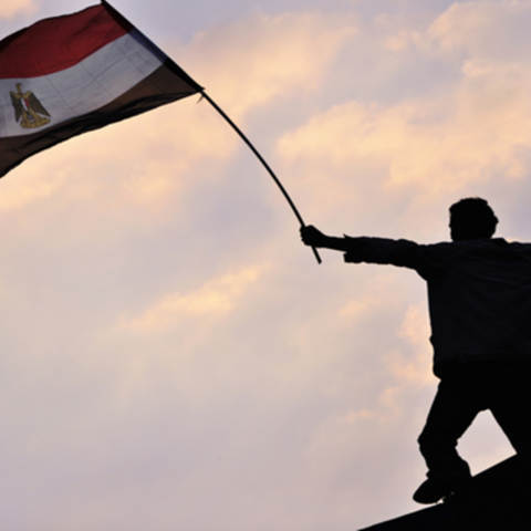 Protester in Cario waving the Egyptian Flag in Tahrir Square.