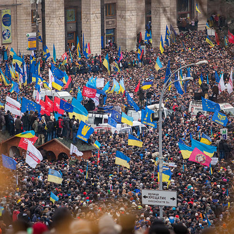 Crowds of people waving Ukrainian flags