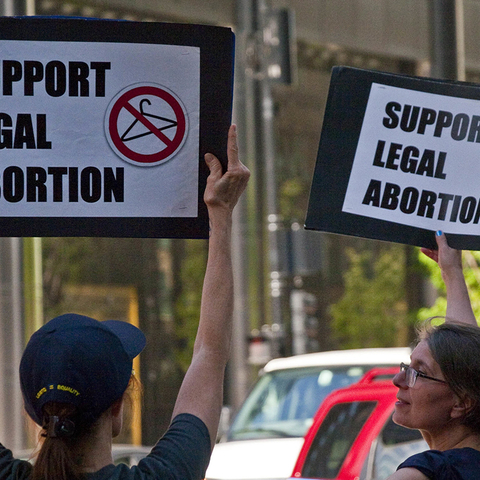 Pro-Choice demonstrators holding signs saying "Support Legal Abortion"